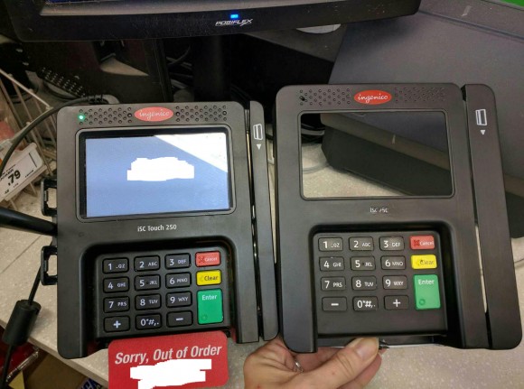 An "overlay" skimming device (right) that was found attached to a card reader at a retail establishment.